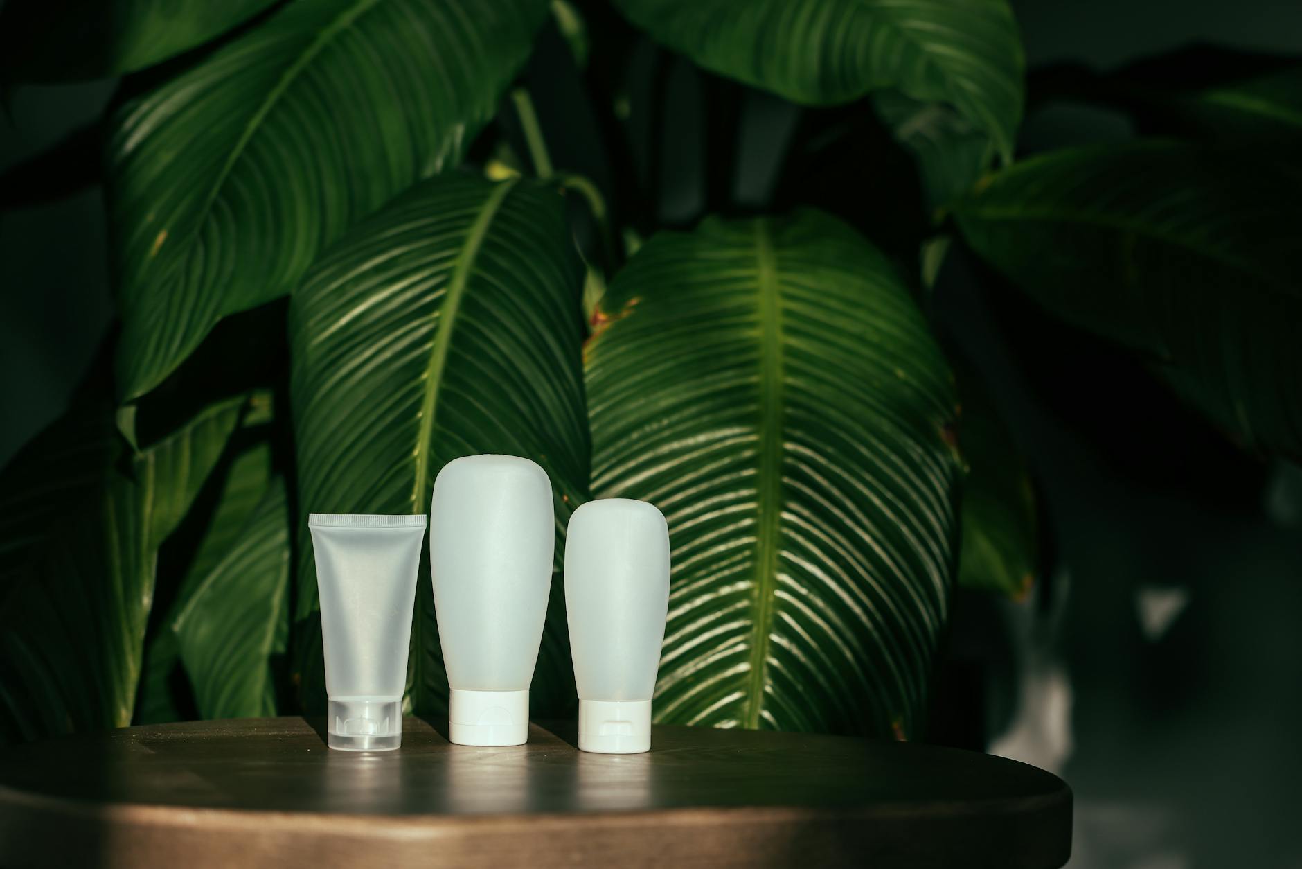 Various refillable cosmetic containers and compacts arranged on a clean surface