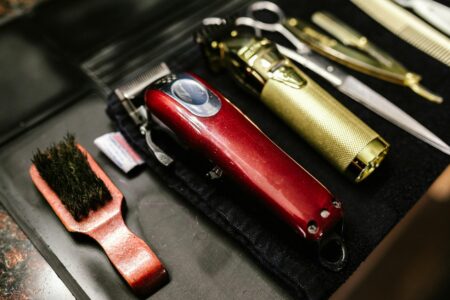 Professional barber tools arranged on clean surface showing modern barbershop equipment