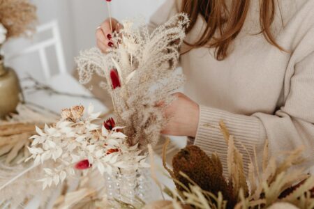 How Wedding Planners Are Incorporating Sustainable Floral Alternatives Elegant dried flower arrangement with pampas grass and preserved roses on rustic wooden table