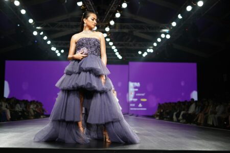 Models walking on fashion runway showcasing contemporary clothing designs
