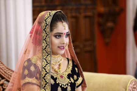 Professional makeup artist applying bridal makeup with brushes and cosmetics