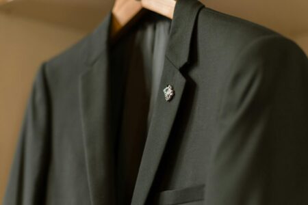 Traditional business suits hanging in a closet, representing the formal wear being replaced by casual alternatives