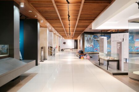 Modern art museum gallery with white walls displaying colorful contemporary artwork