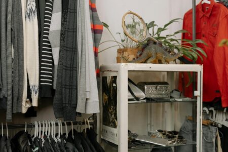 Colorful vintage clothing hanging on rack in thrift store