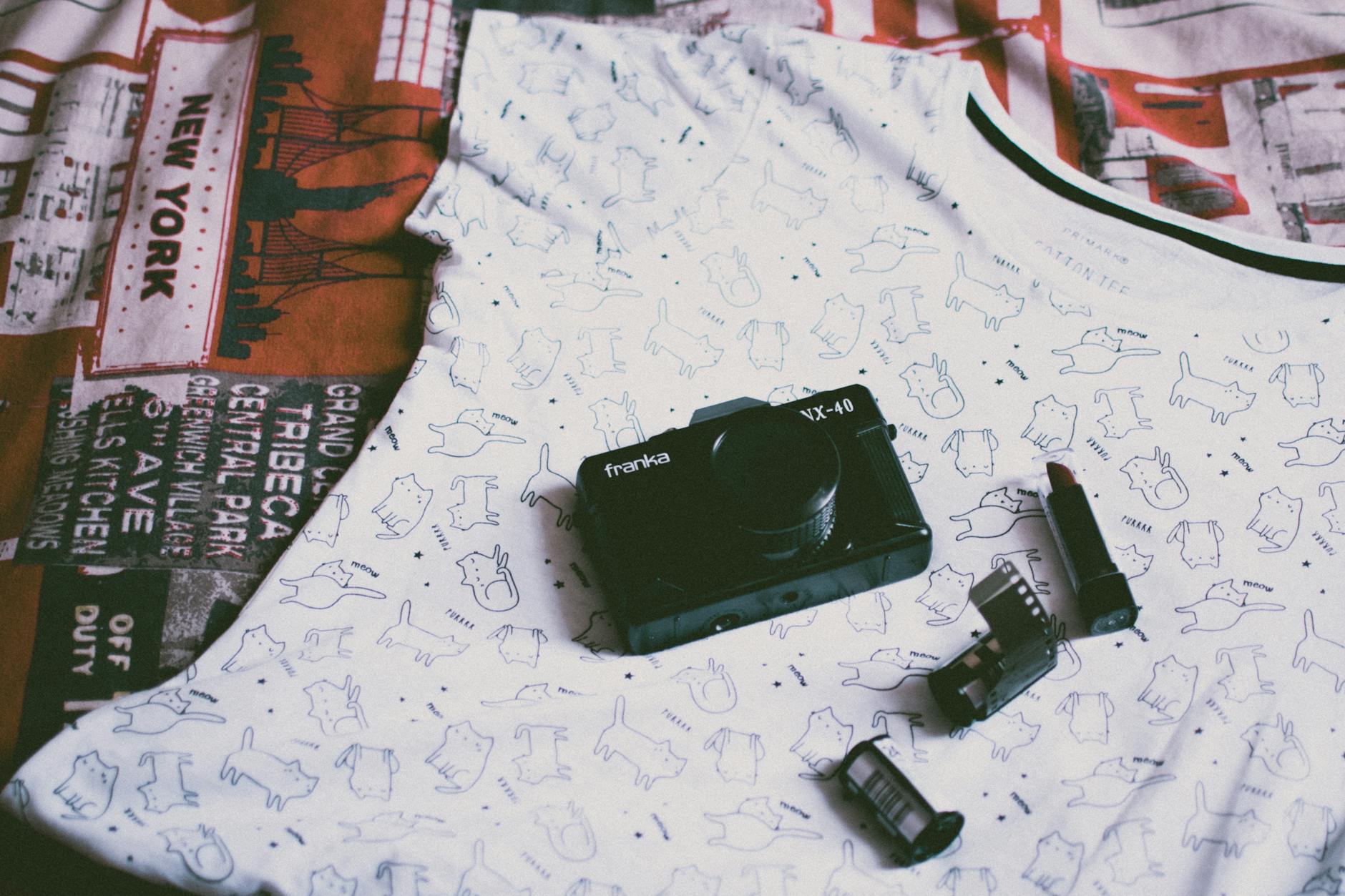 Person holding vintage instant camera as fashion accessory