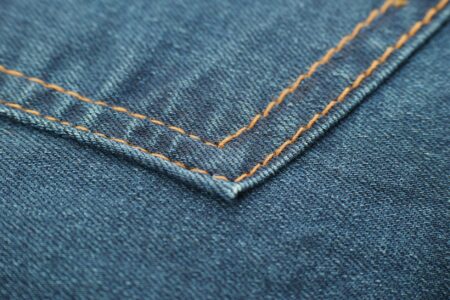 Close-up of premium denim fabric showing texture and weave detail