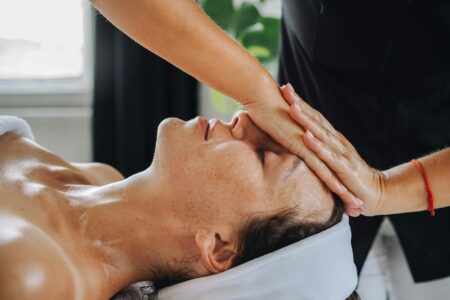 Professional facial massage treatment showing pressure point technique application