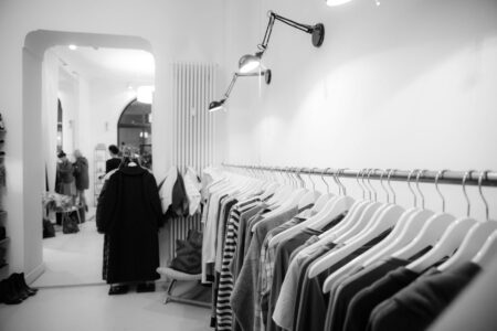 Collection of vintage band t-shirts hanging on clothing rack showing various classic rock merchandise