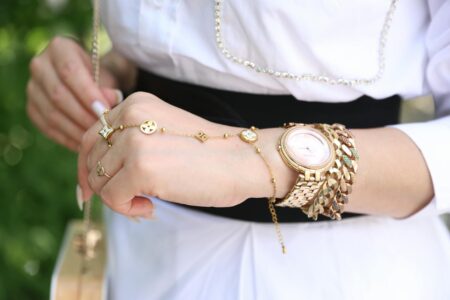 How Gen Z Is Reviving 1990s Minimalist Jewelry Delicate minimalist gold jewelry pieces laid out on clean white surface