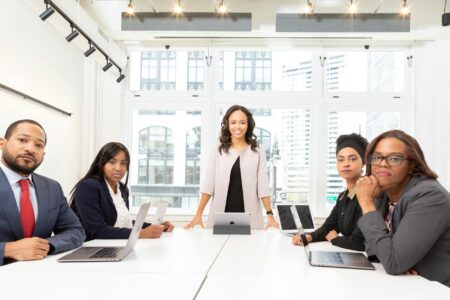 Corporate Executives Are Embracing Visible Tattoos in Professional Settings Professional business meeting with executives around conference table