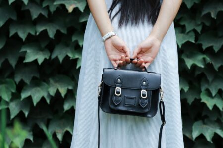 Collection of vintage designer handbags displayed on white surface