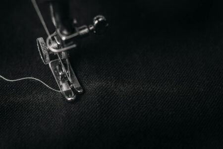 Industrial sewing machine working on luxury fabric in textile manufacturing setting