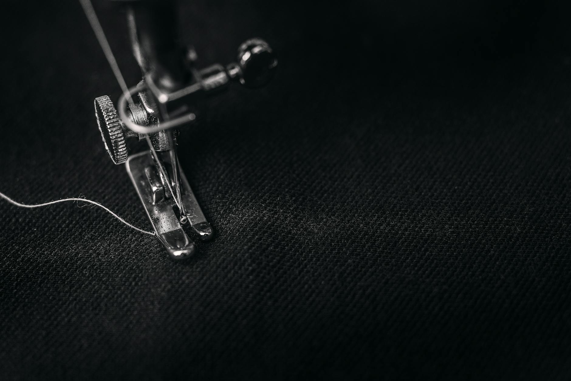 Industrial sewing machine working on luxury fabric in textile manufacturing setting