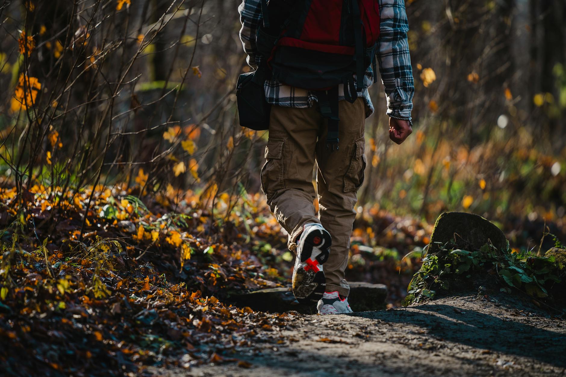 Person wearing structured cargo pants with multiple pockets in utilitarian style