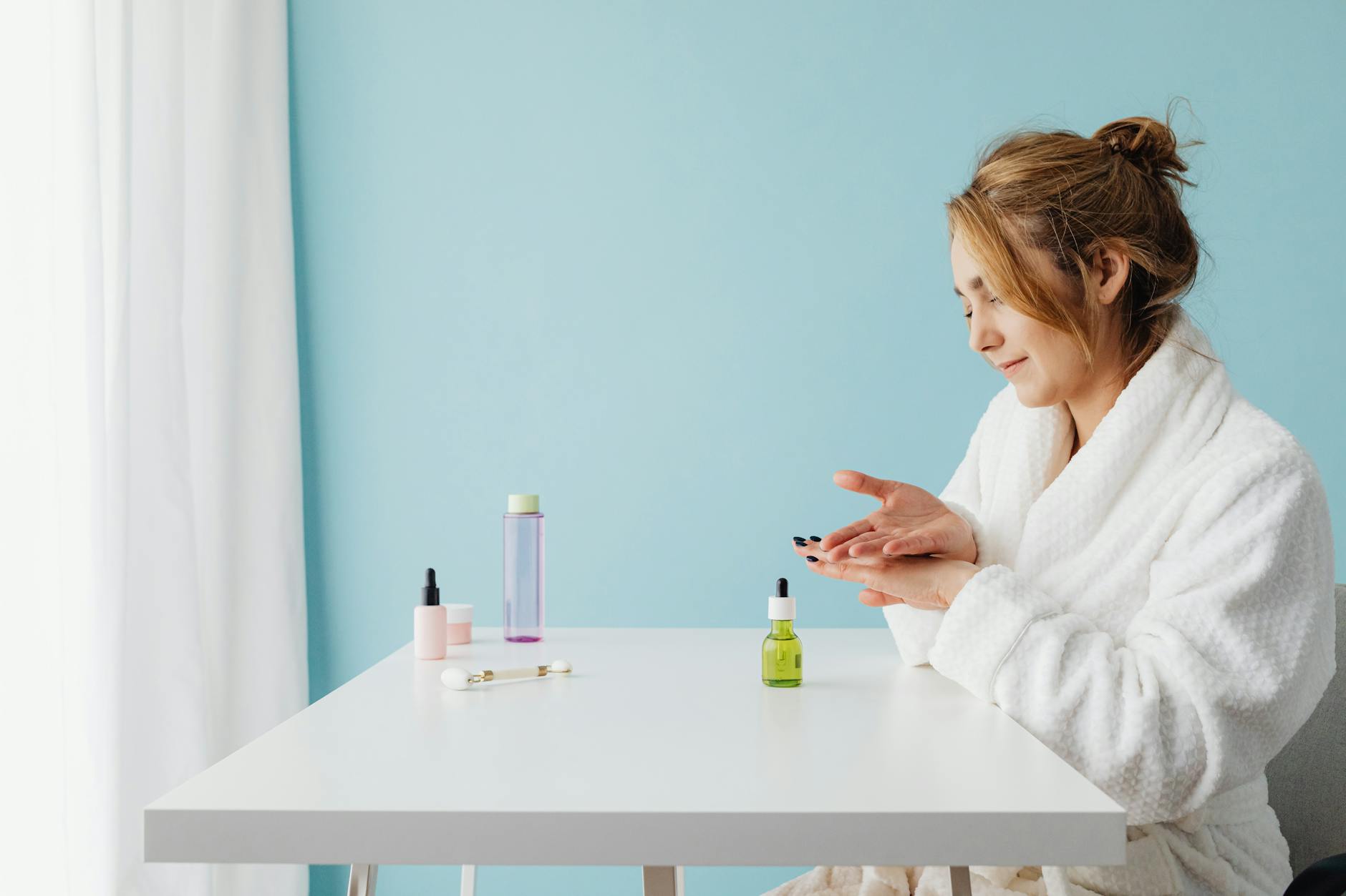 Woman applying skincare products in multiple steps for Korean beauty routine