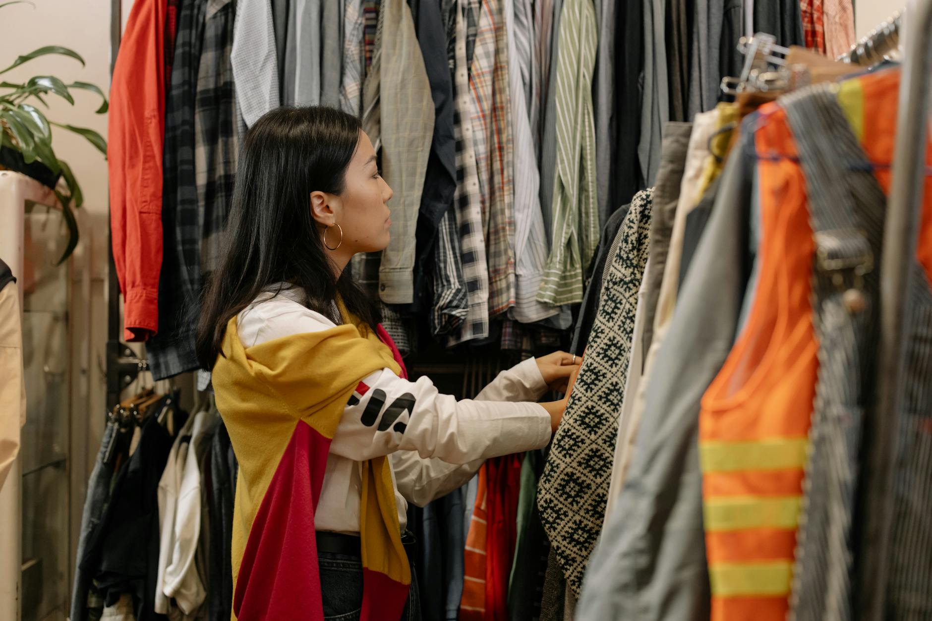 Colorful vintage clothing hanging on racks in a well-organized thrift store