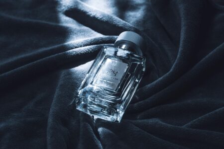 Modern minimalist perfume bottles in neutral colors arranged on a clean surface