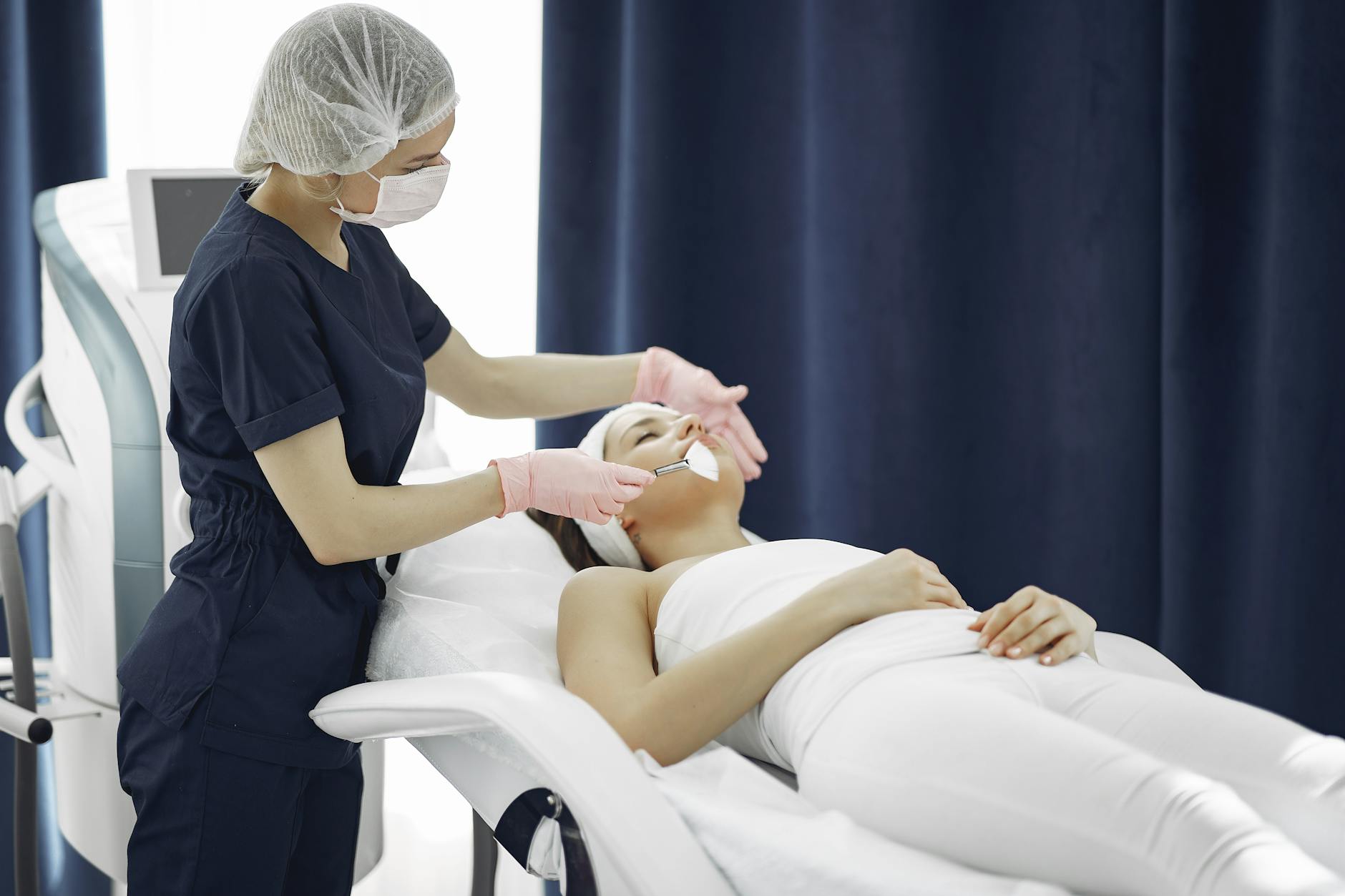 Professional spa treatment room with modern cryotherapy equipment for facial treatments