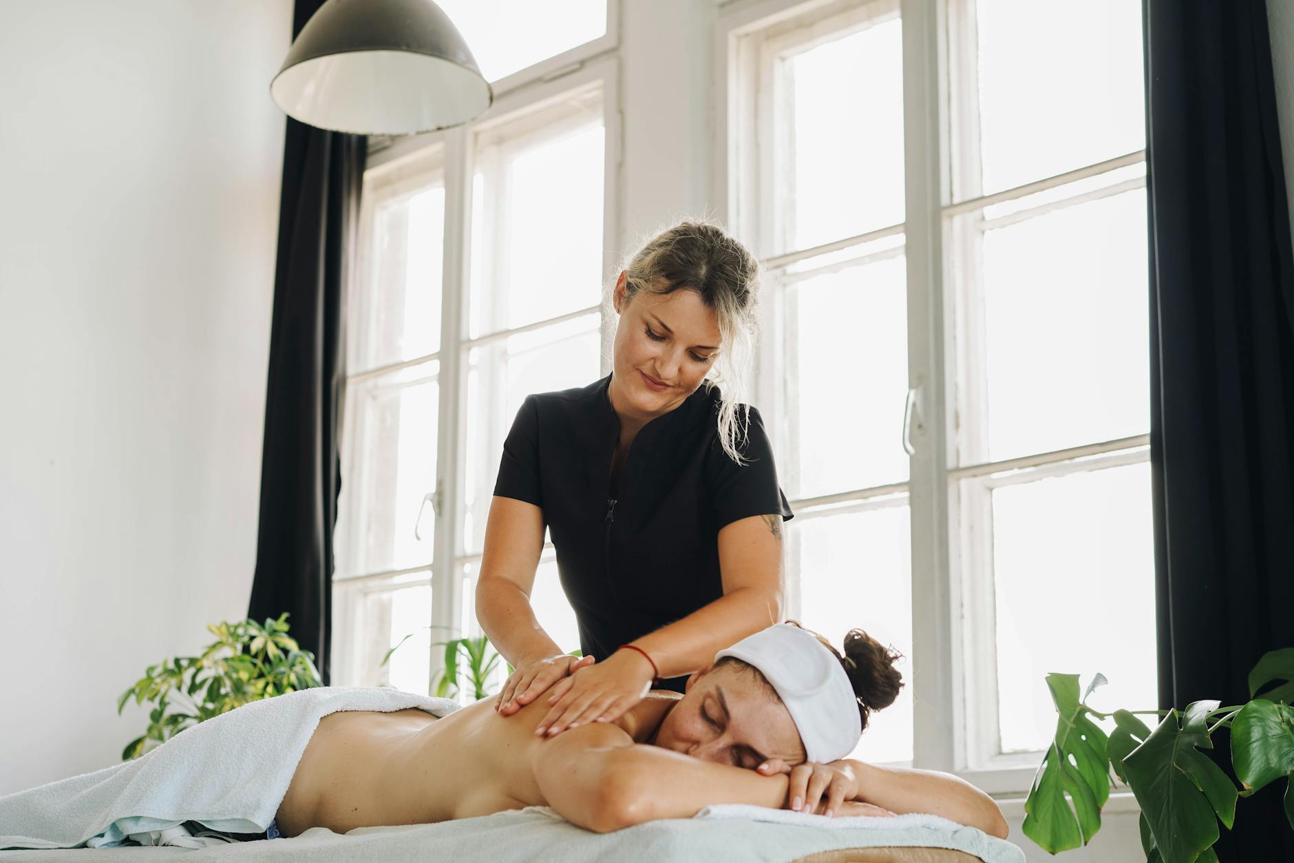 Serene spa treatment room with natural lighting and wellness equipment