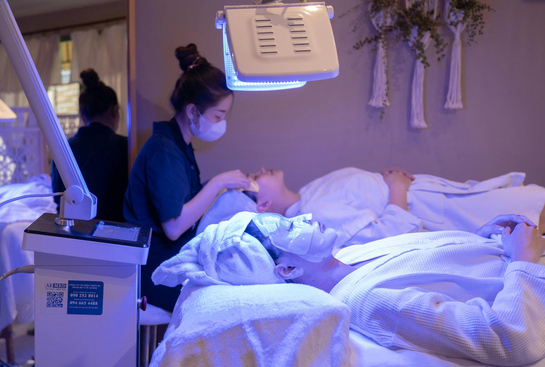 Professional aesthetician performing facial treatment on client