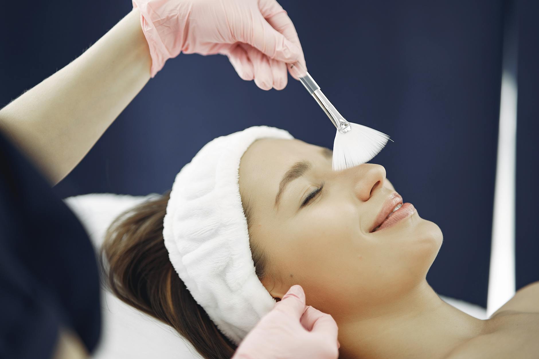 Woman receiving professional facial treatment at luxury spa