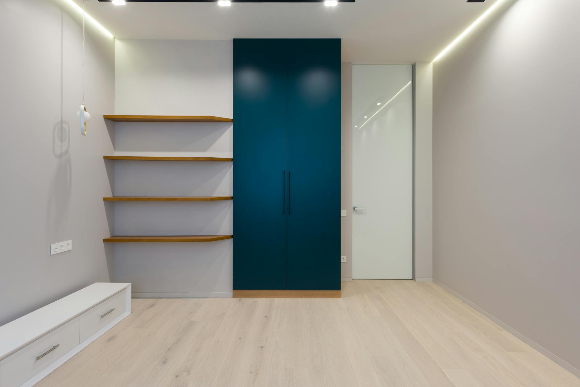 Clean, organized wardrobe with minimal clothing items hanging in neutral colors