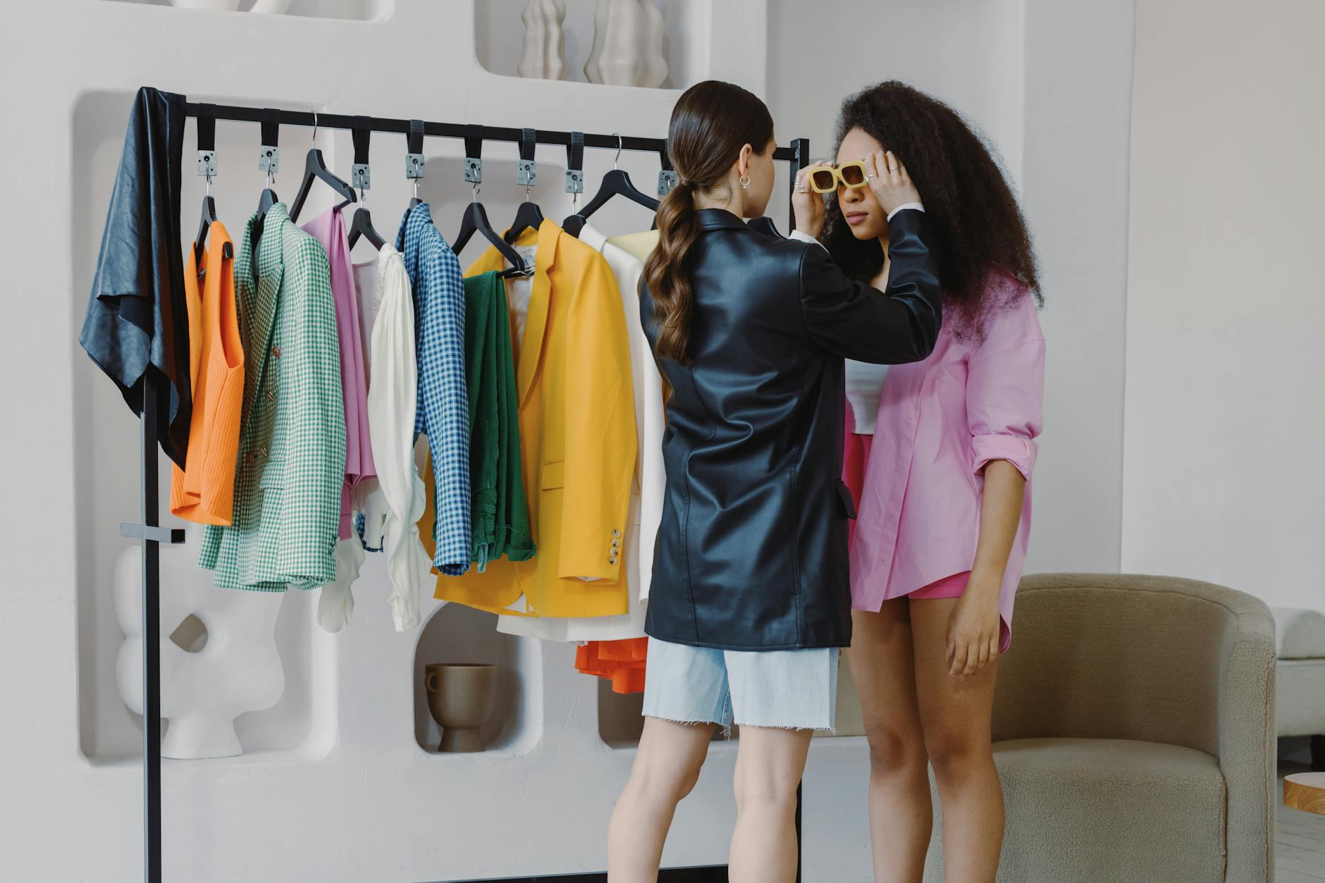 Fashion accessories and styling elements laid out on clean surface showing luxury fashion details