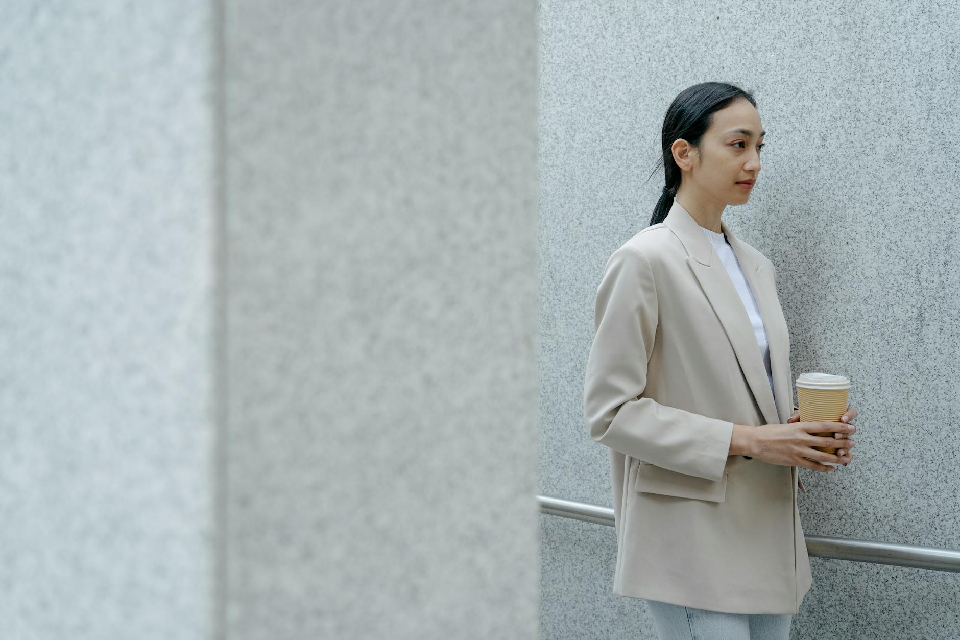 Woman wearing simple neutral dress embodying monastery minimalist fashion aesthetic