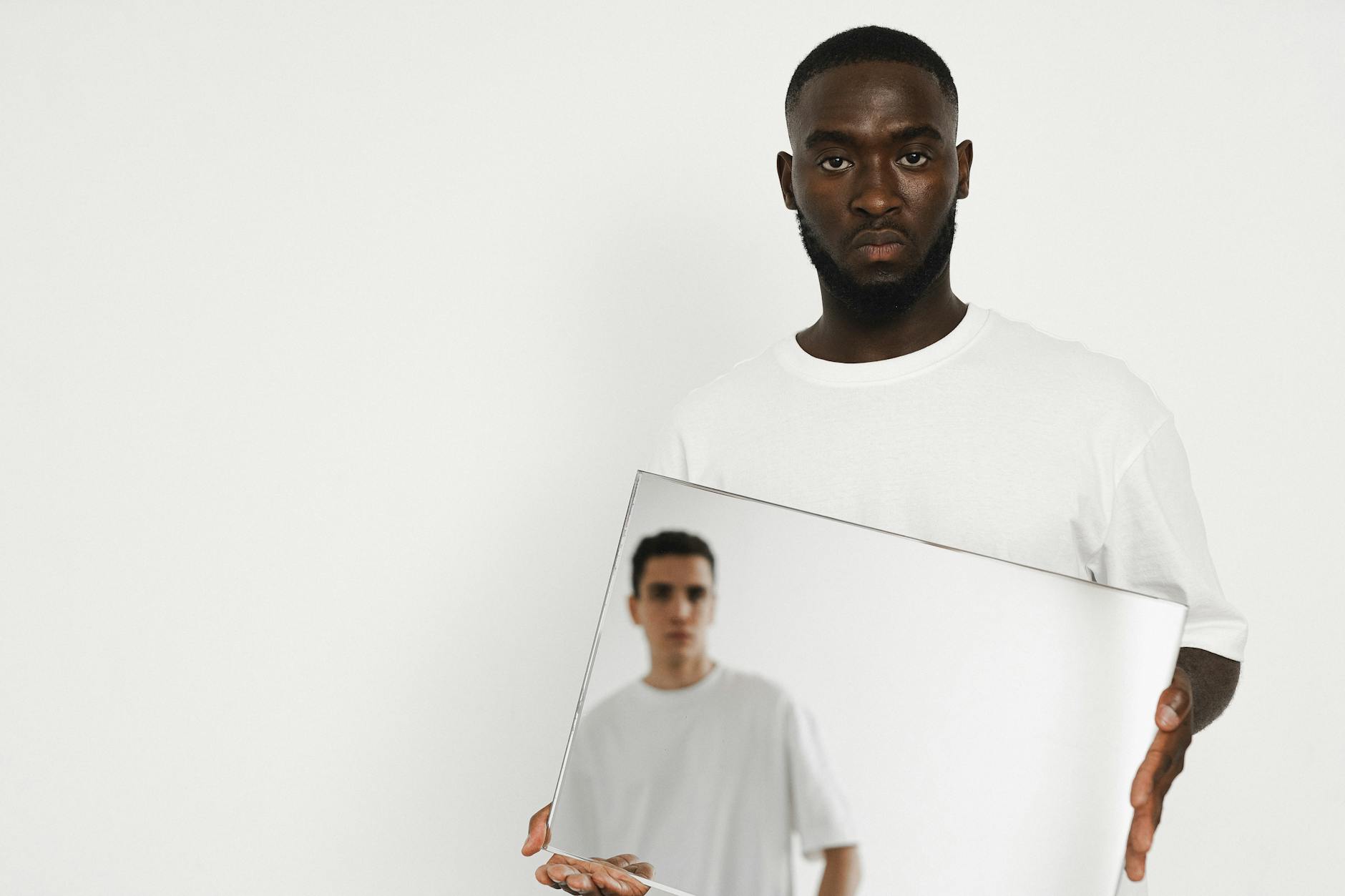 Man examining his face closely in a mirror