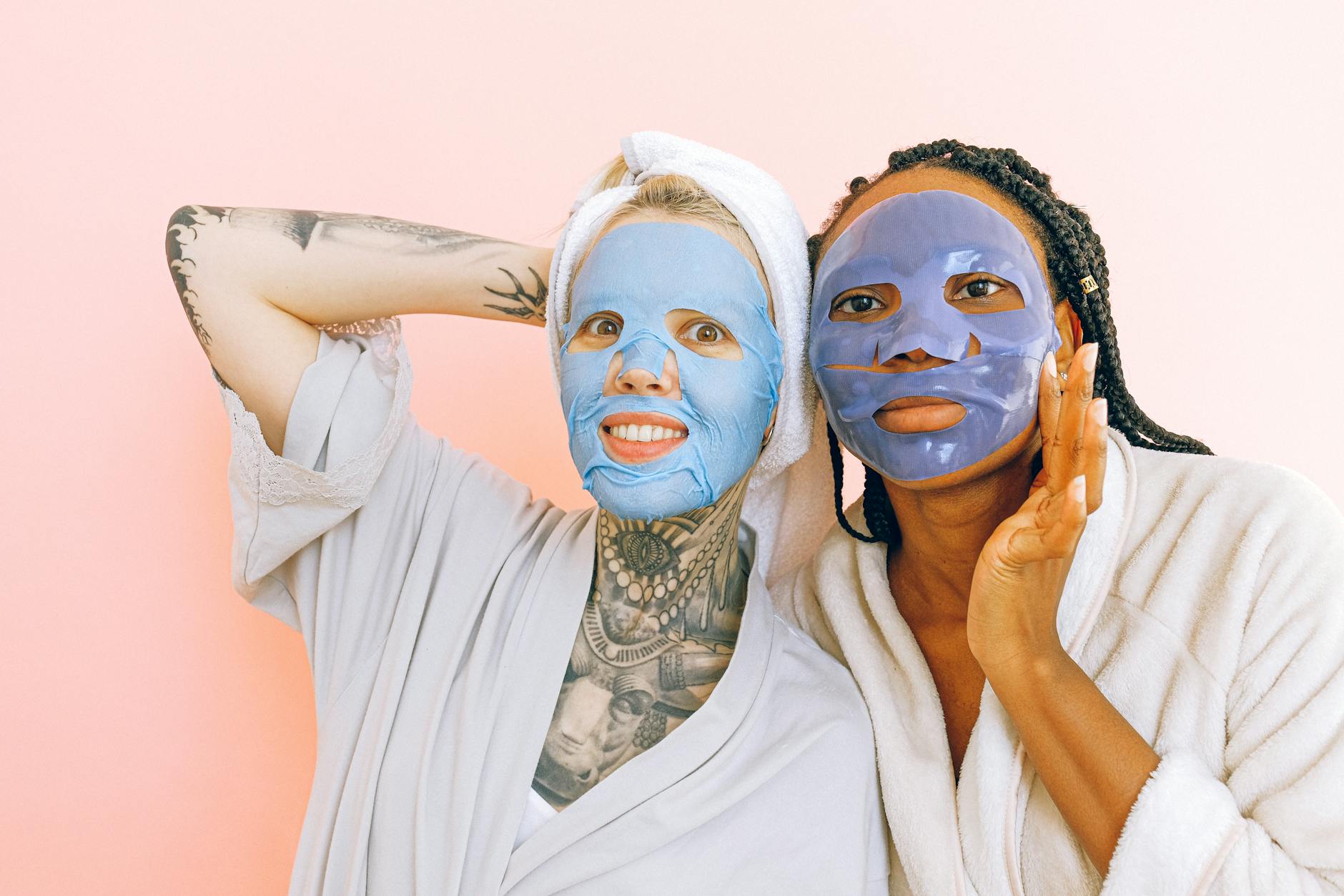 Woman receiving professional facial treatment with black charcoal mask at spa