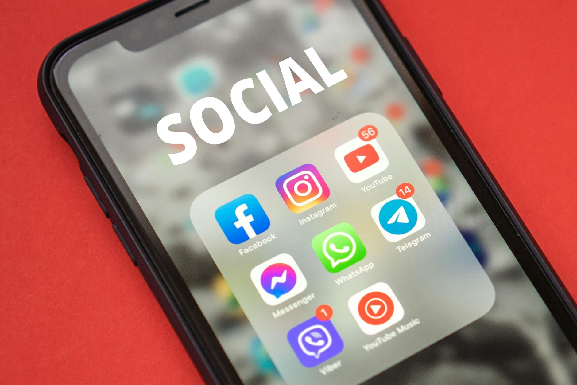Person holding smartphone displaying social media content and fashion posts
