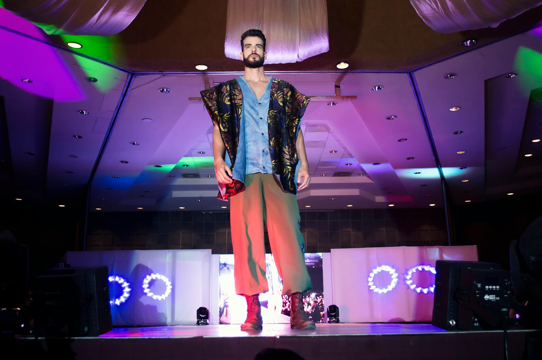 Models walking fashion show runway showcasing contemporary outerwear collections