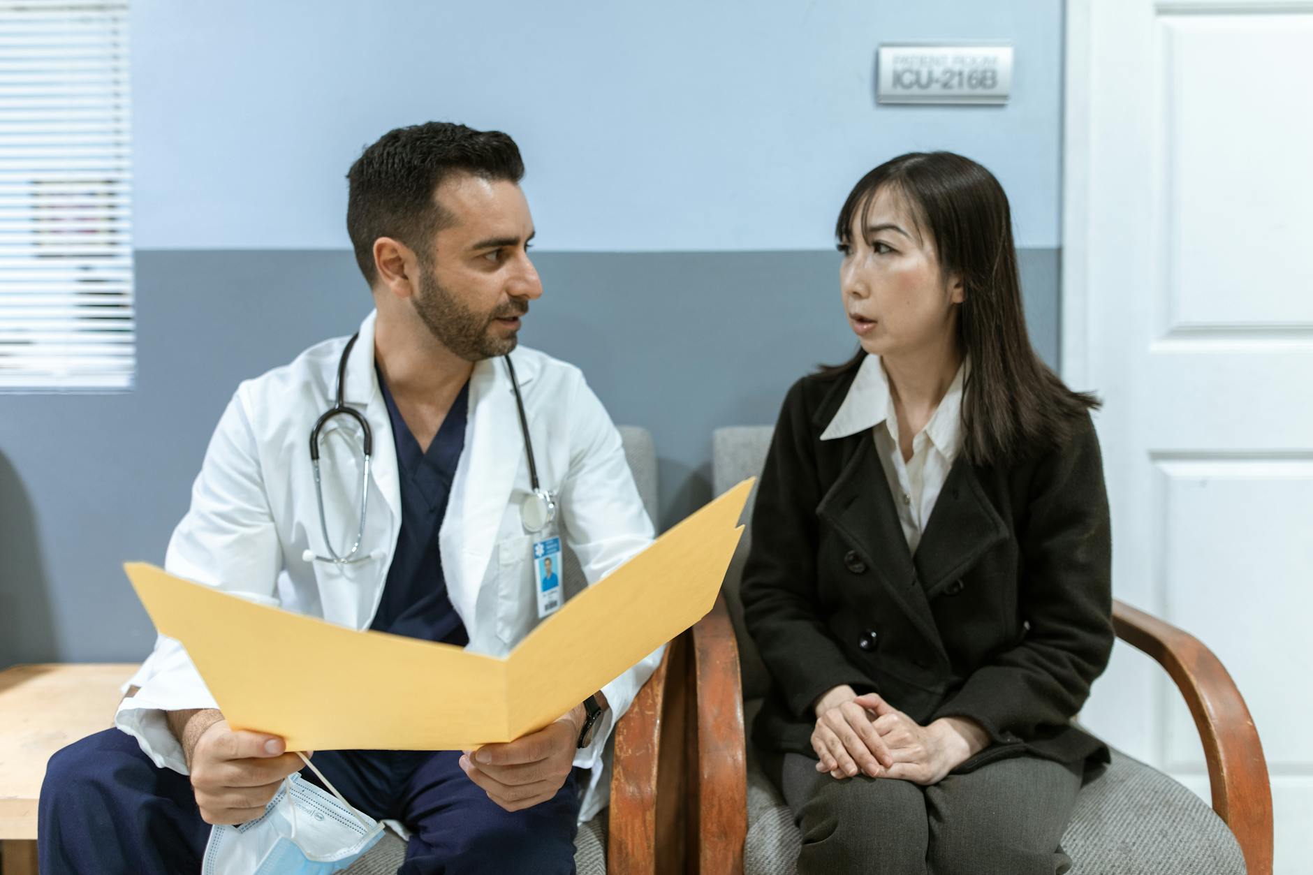Dermatologist explaining LED light therapy treatment options to patient in clinical setting