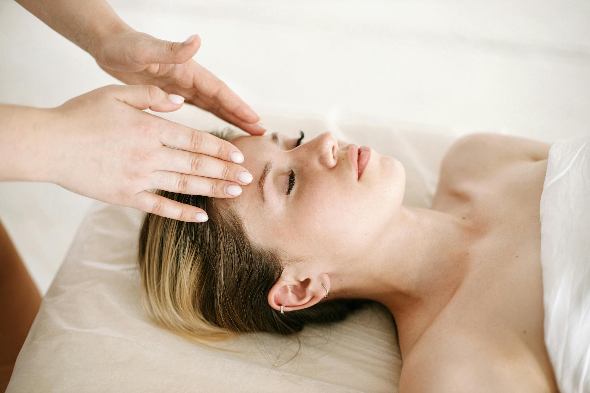 Close-up of reflexologist hands performing precise pressure point therapy technique