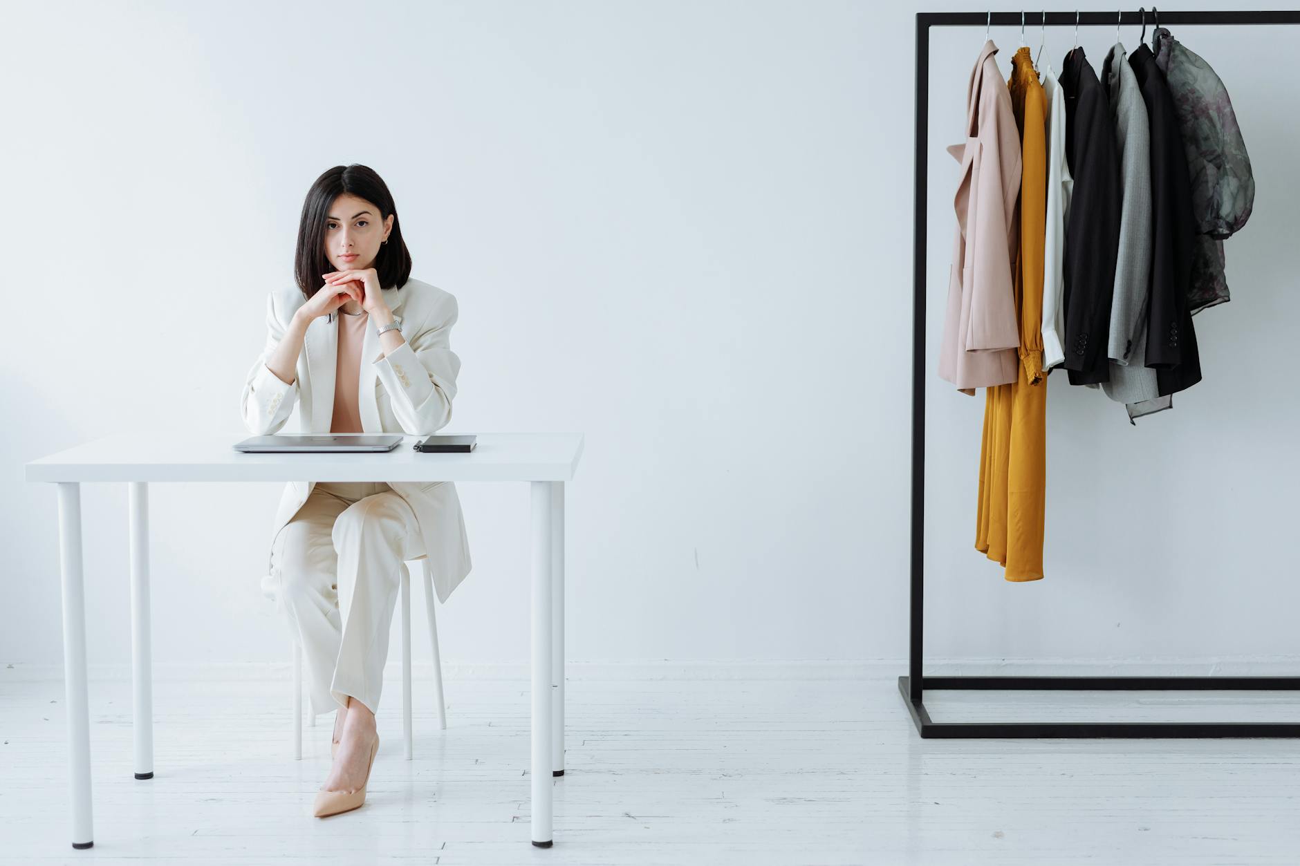 Collection of structured professional blazers hanging in organized closet space