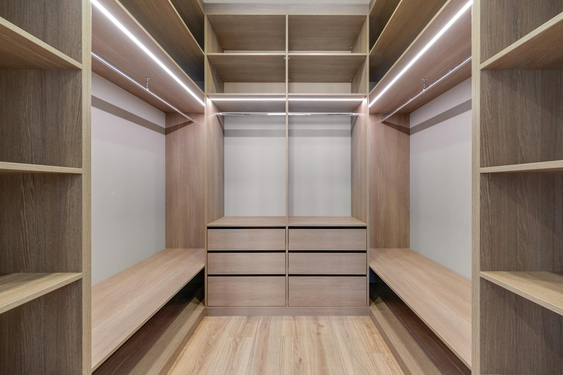 Organized capsule wardrobe with neutral pieces demonstrating monastery minimalist approach