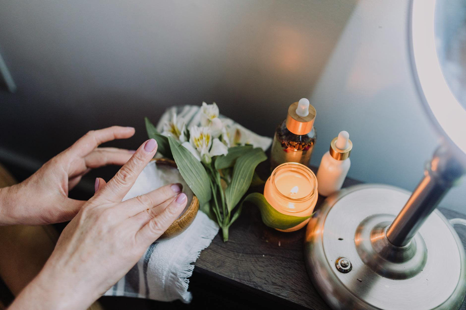 Professional hands applying skincare treatment showing proper clinical application technique