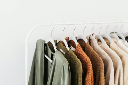 Quiet Luxury’s Grip on Fashion Is Finally Loosening Minimalist beige and neutral-toned clothing hanging in a wardrobe, representing quiet luxury fashion aesthetic