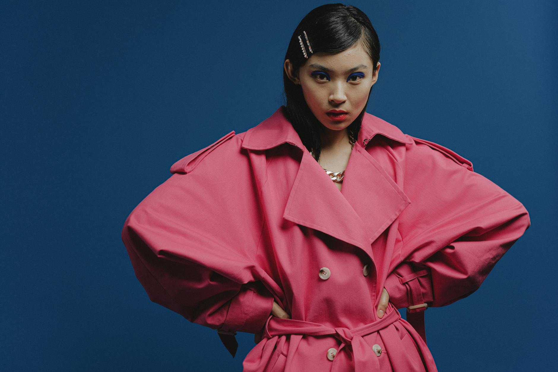 Vibrant and colorful fashion pieces on display, contrasting with minimalist quiet luxury styling