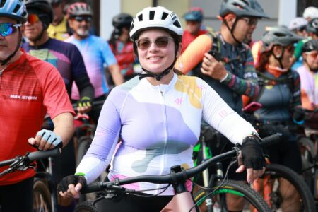 Cycling Kit Aesthetics Are Pedalling Into Luxury Casual Wear Brightly colored cycling jerseys displayed in a row, showing bold color blocking and technical construction