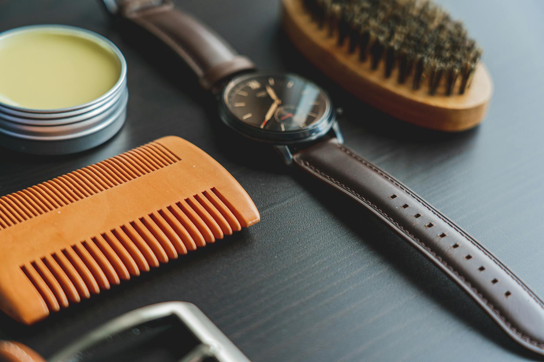 High-end fashion accessories arranged in a styled editorial flatlay