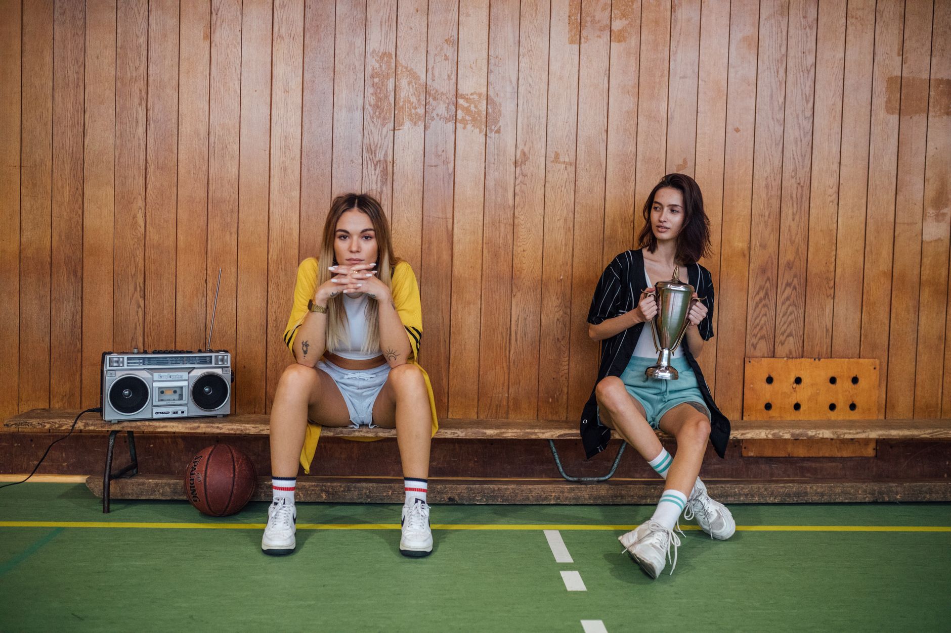 Woman in athletic-inspired casual outfit with color-blocked pieces and white sneakers
