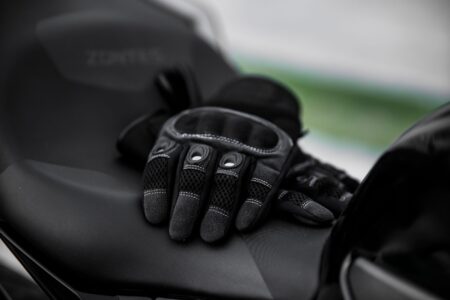 Close-up of tan cabretta leather polo riding gloves with snap closure detail