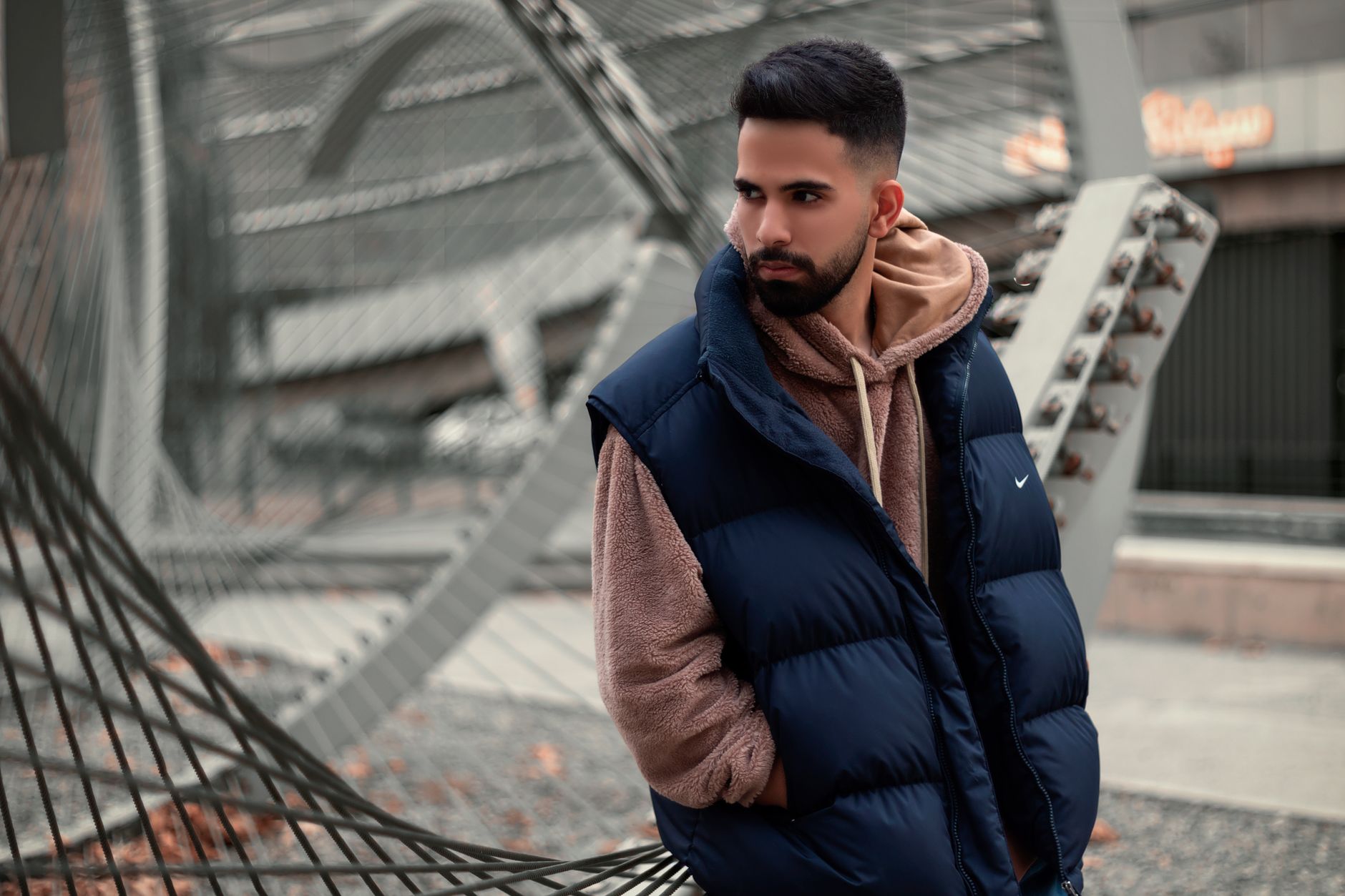 Structured padded vest with chest panel detailing laid flat on a surface