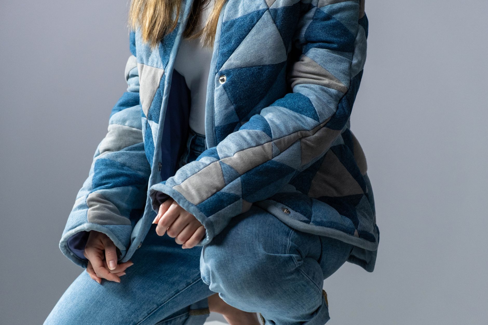 Close-up of a quilted jacket shoulder with structured padding and diamond stitch detail