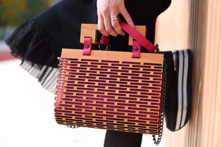 Flat Water Kayak Cockpit Rims Are Quietly Edging Into Structured Bag Frames A structured leather handbag with a rigid oval opening frame on a neutral background
