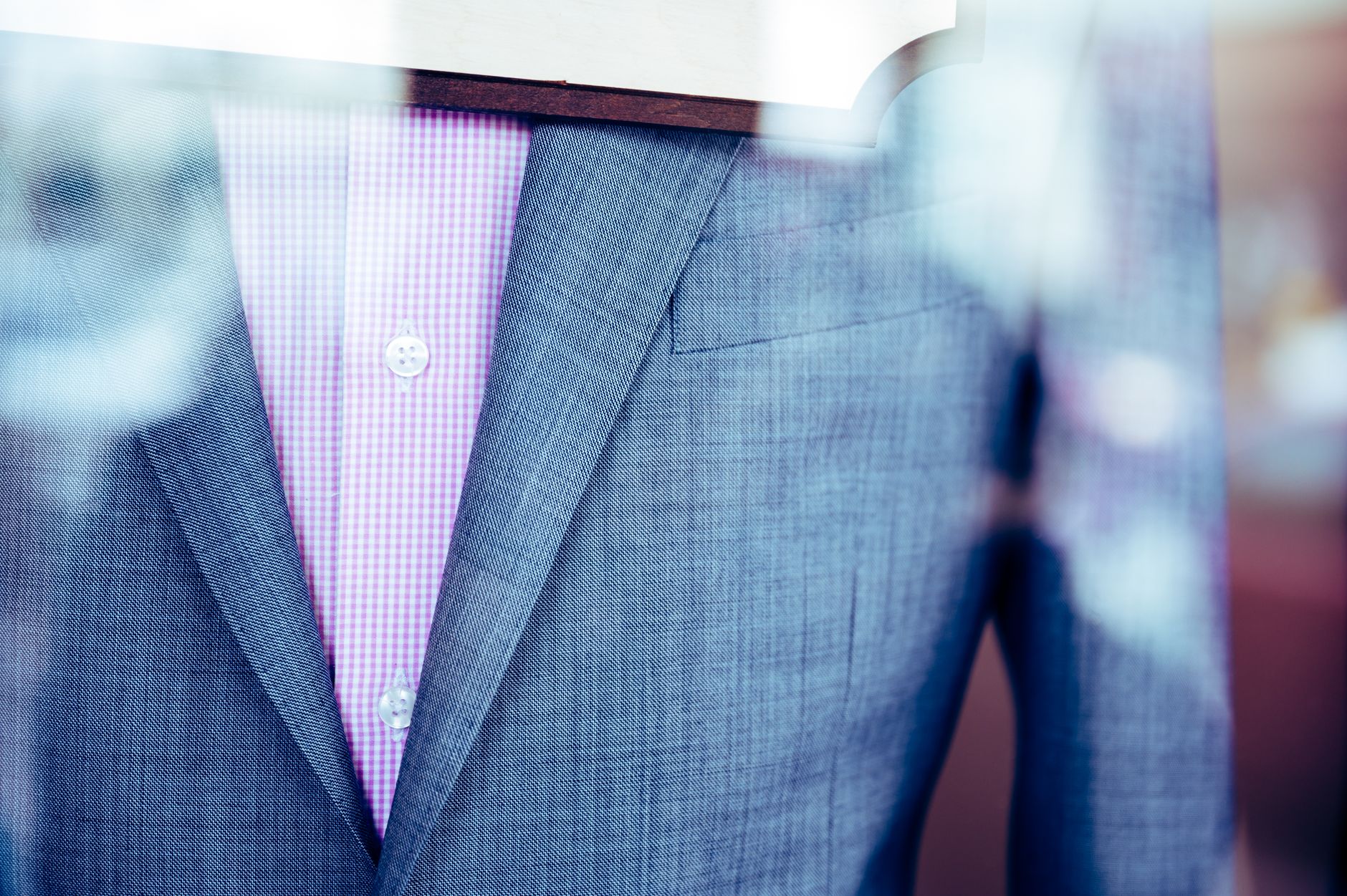 Close-up detail of tailored suit fabric and collar styling