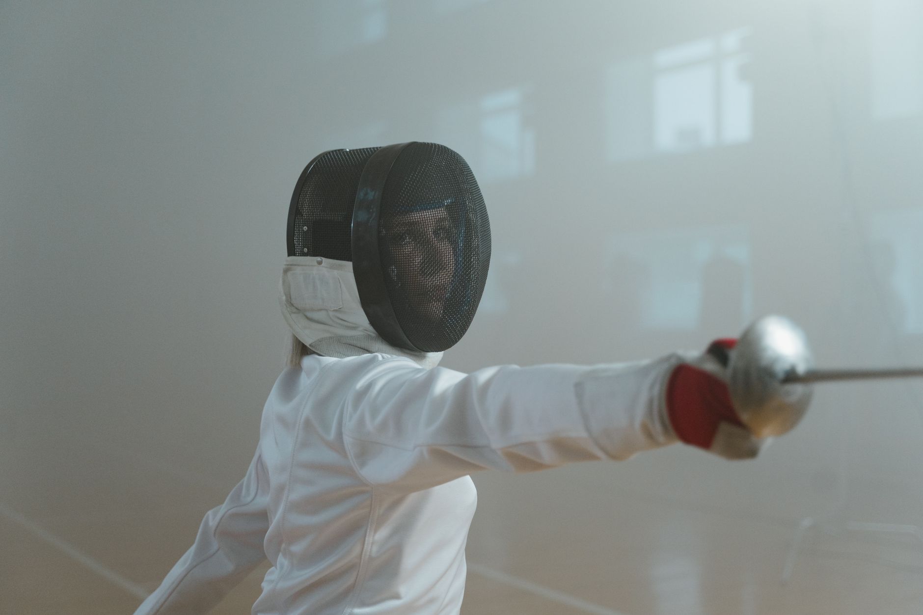 Close-up of fencing protective equipment including a quilted plastron chest protector laid flat