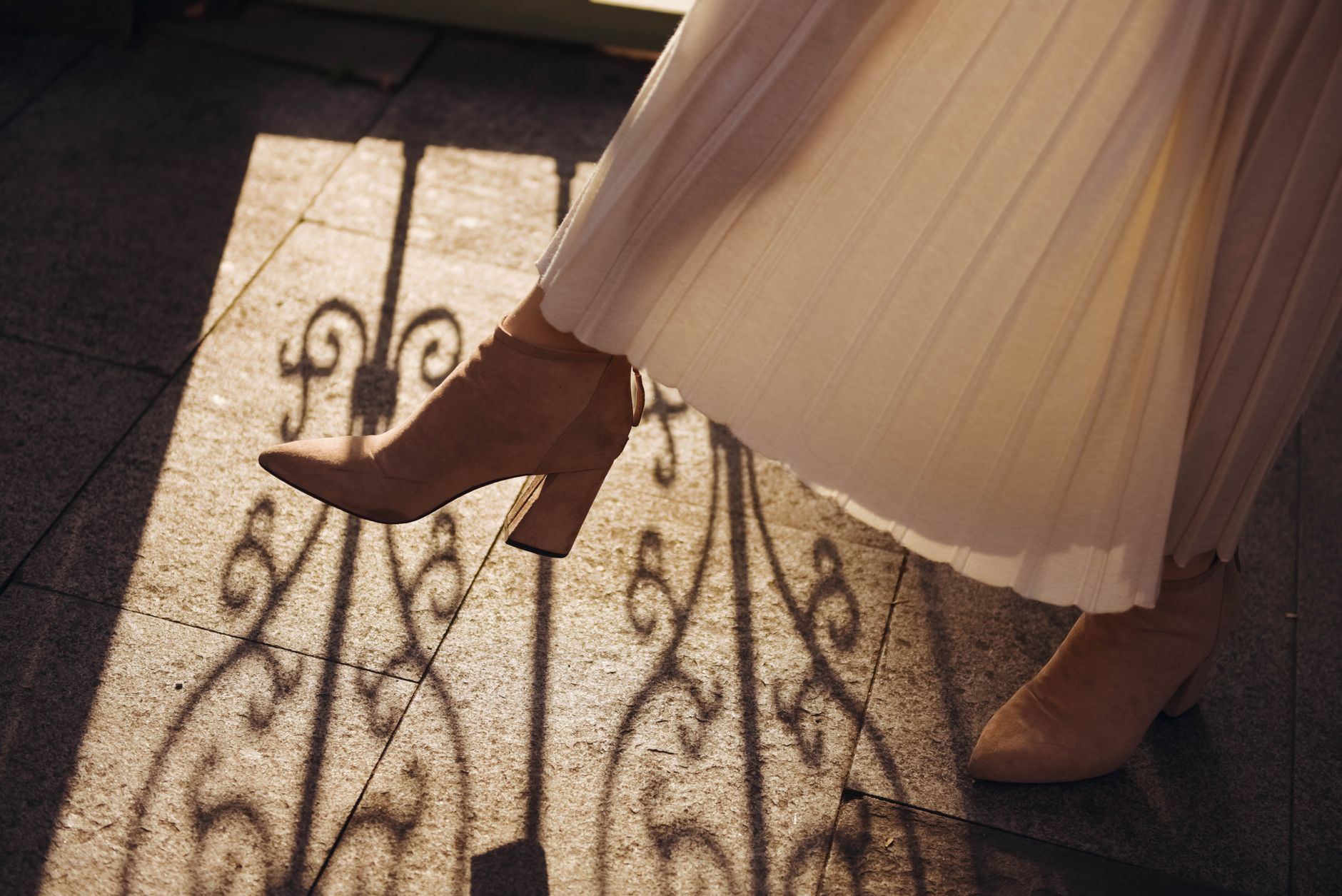 Close-up of a structured pleated skirt with panel stitching detail in heavy cotton fabric