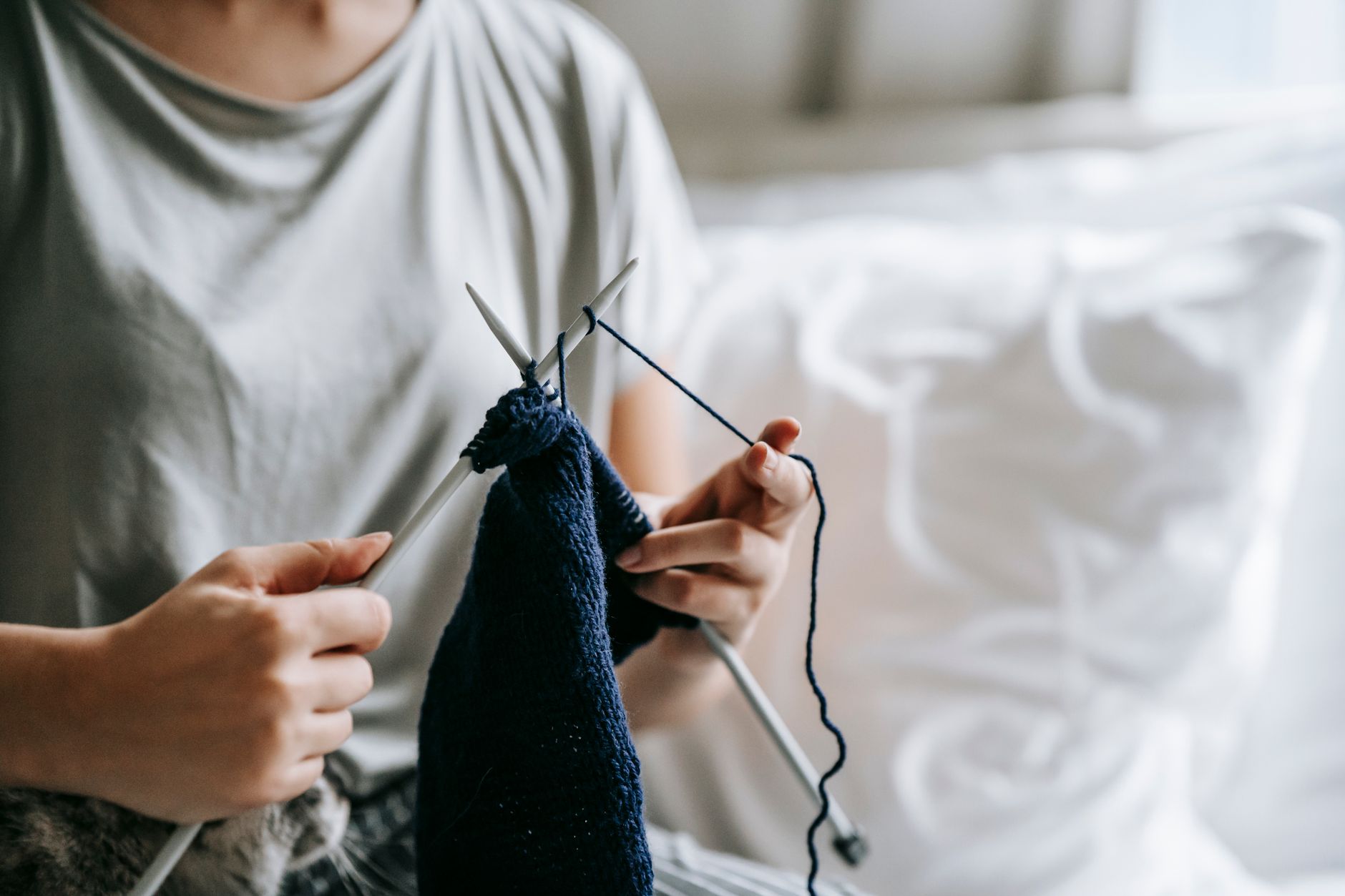 Knit garments displayed in a minimalist fashion studio setting